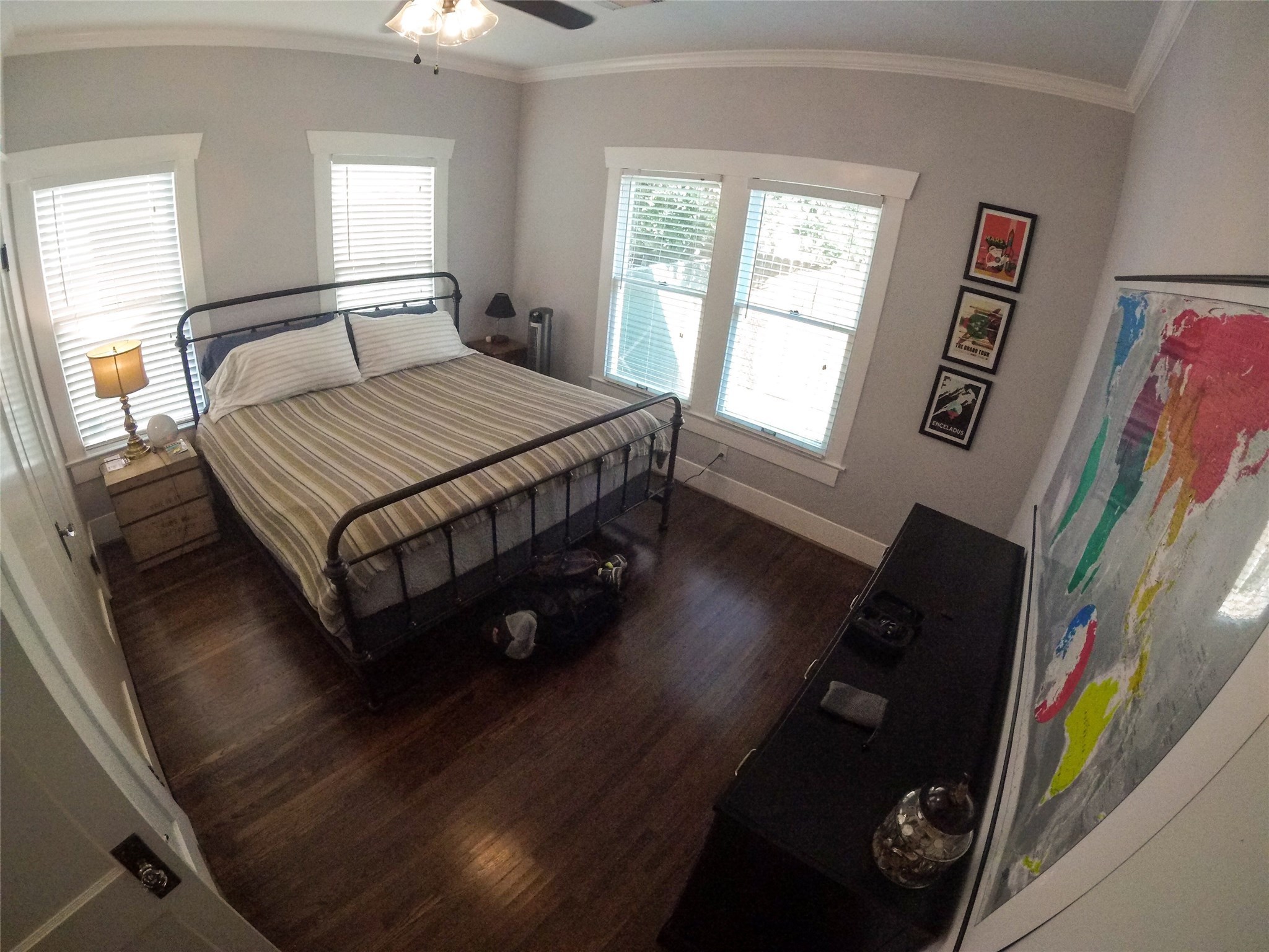 210 Tabor Street Houston, TX 77009 - Photo 17 of 20 a bedroom with a bed painting on wall and a large window