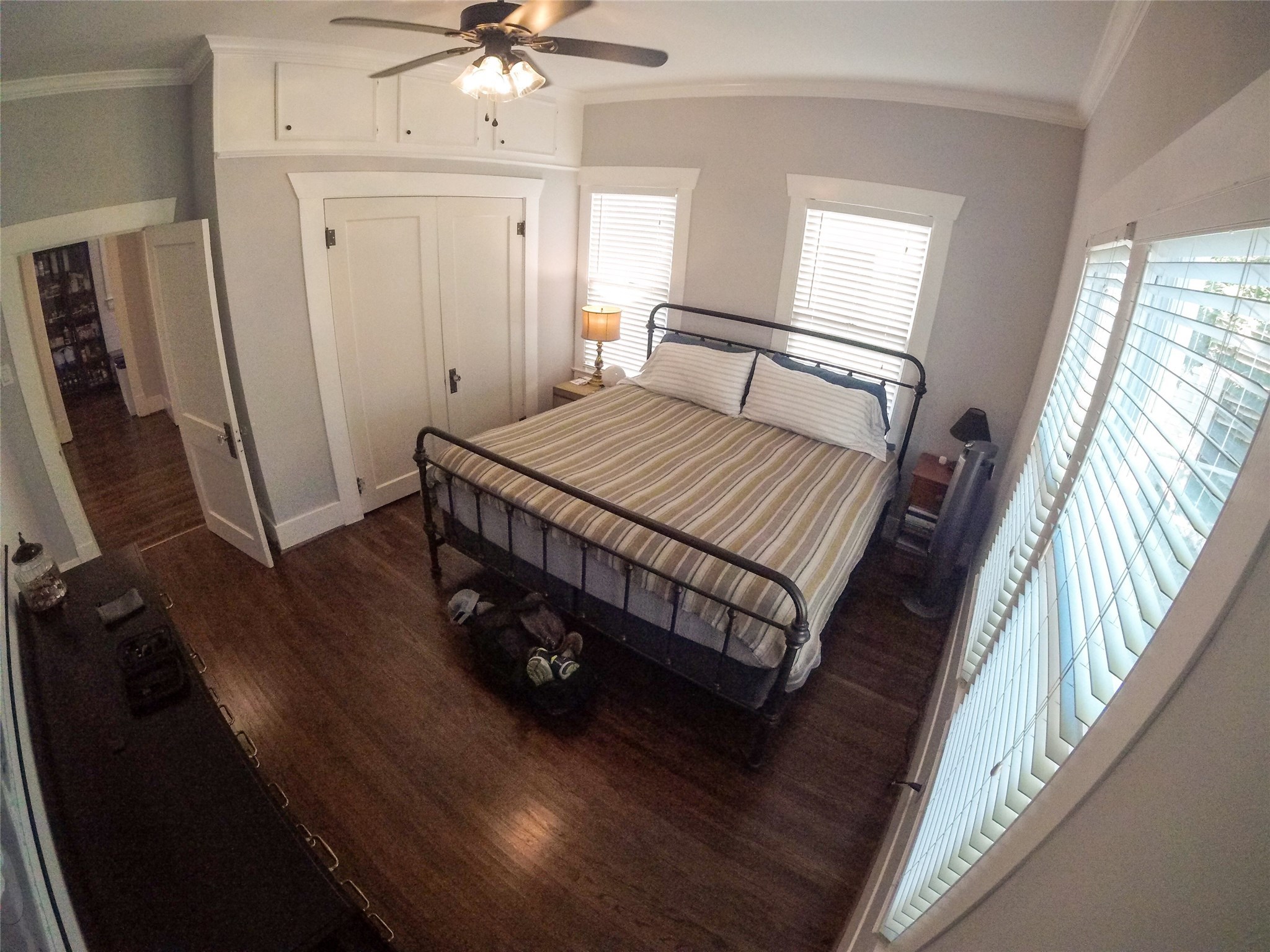 210 Tabor Street Houston, TX 77009 - Photo 18 of 20 a bedroom with a bed window and a flat screen tv