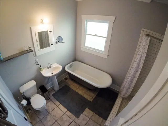 a bathroom with a toilet sink a mirror and vanity