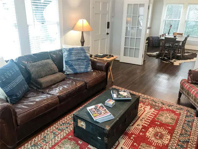 a living room with furniture and wooden floor