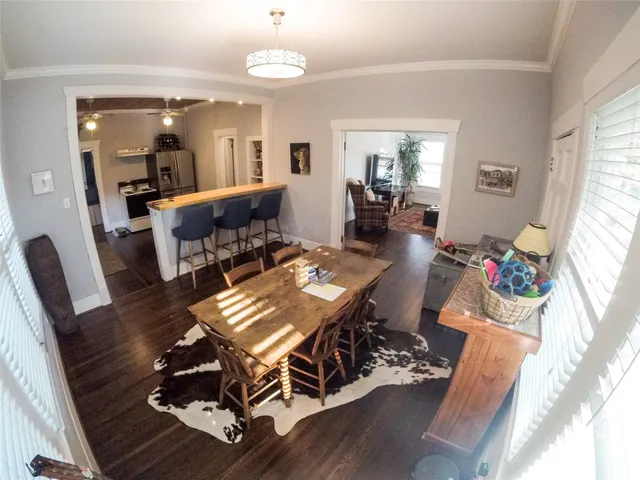 a view of a dining room with furniture wooden floor and a chandelier