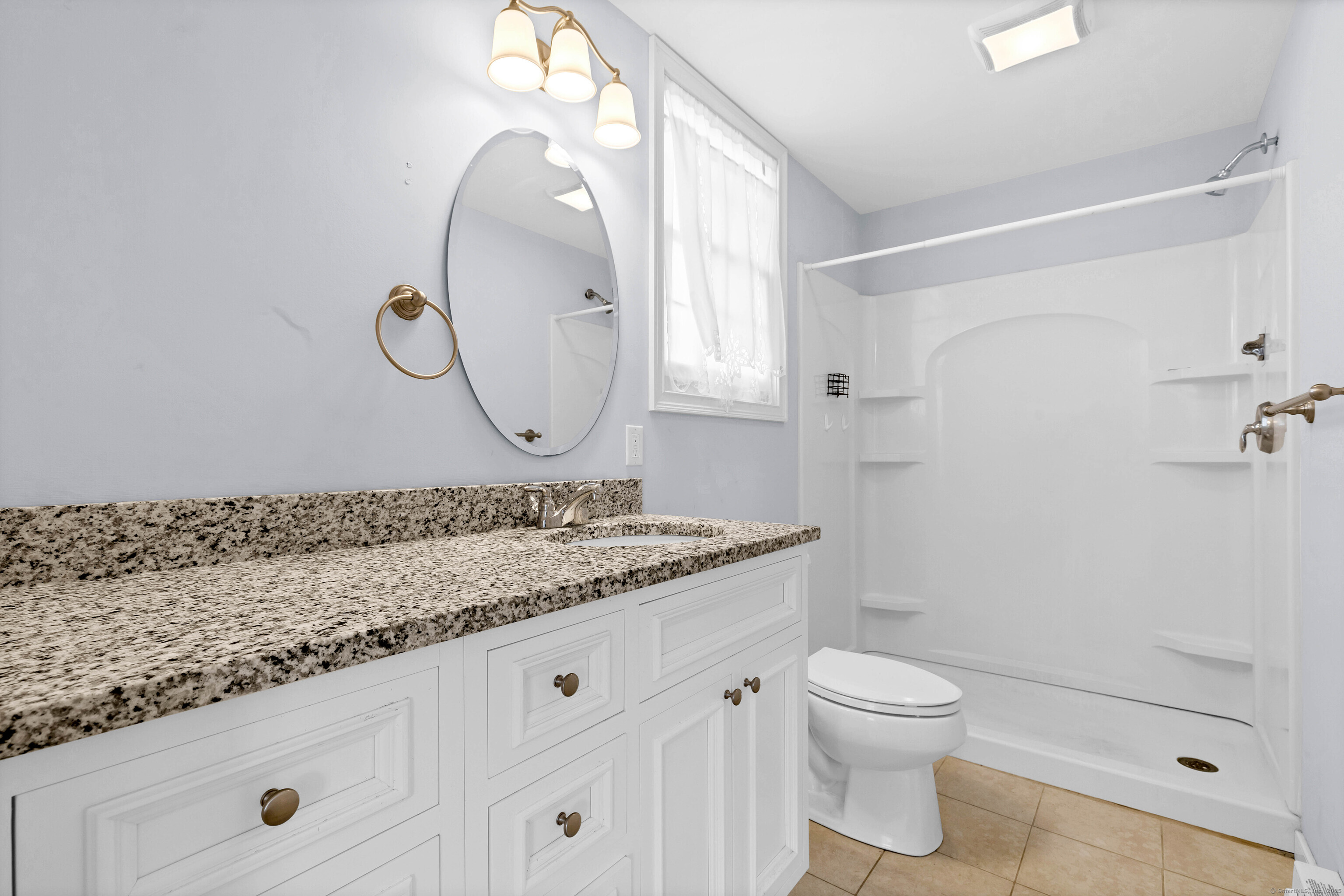9 Brewer Street New London, CT 06320 - Photo 12 of 40 a bathroom with a granite countertop sink mirror toilet and shower