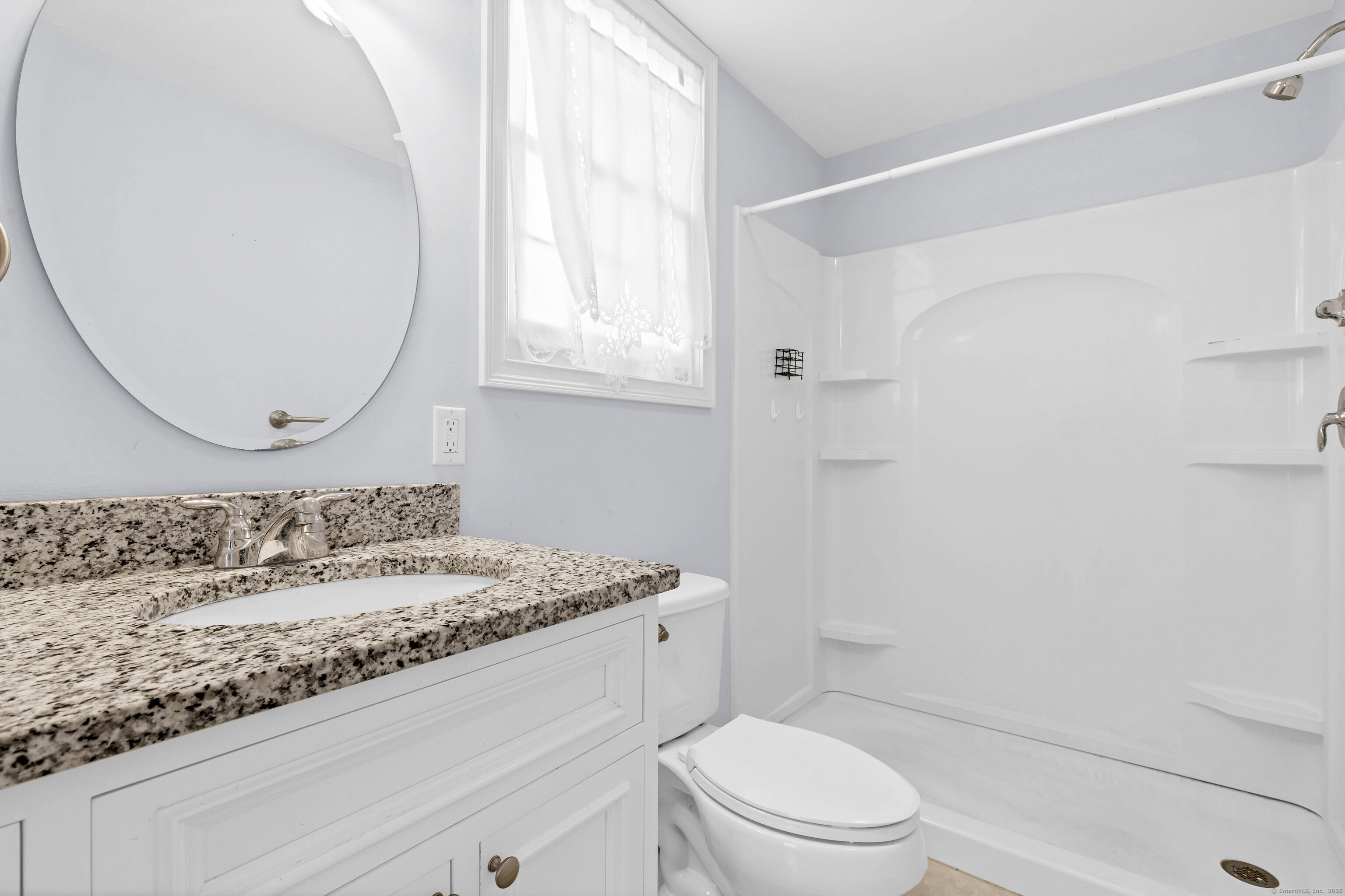 9 Brewer Street New London, CT 06320 - Photo 13 of 40 a bathroom with a granite countertop sink a toilet and a mirror