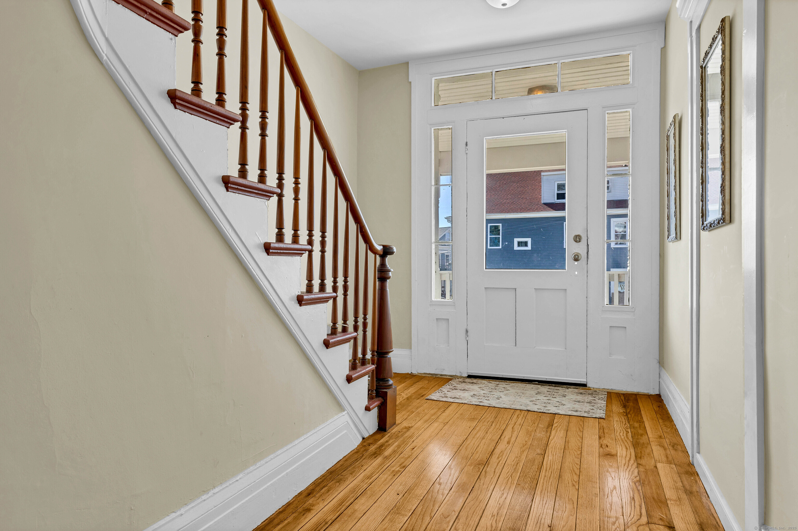 9 Brewer Street New London, CT 06320 - Photo 14 of 40 a view of front door with wooden floor and stairs