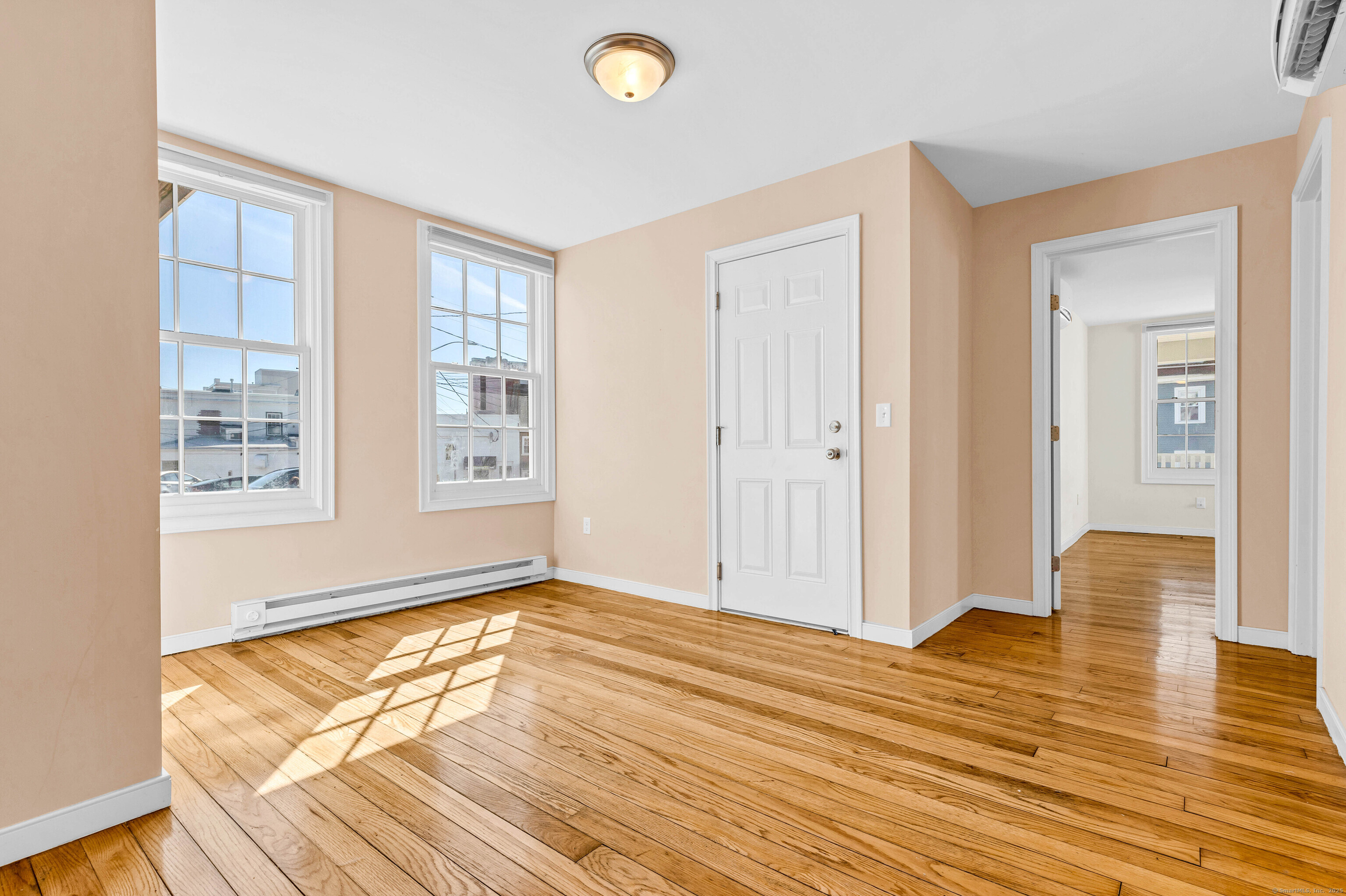 9 Brewer Street New London, CT 06320 - Photo 17 of 40 a view of empty room with wooden floor and fan