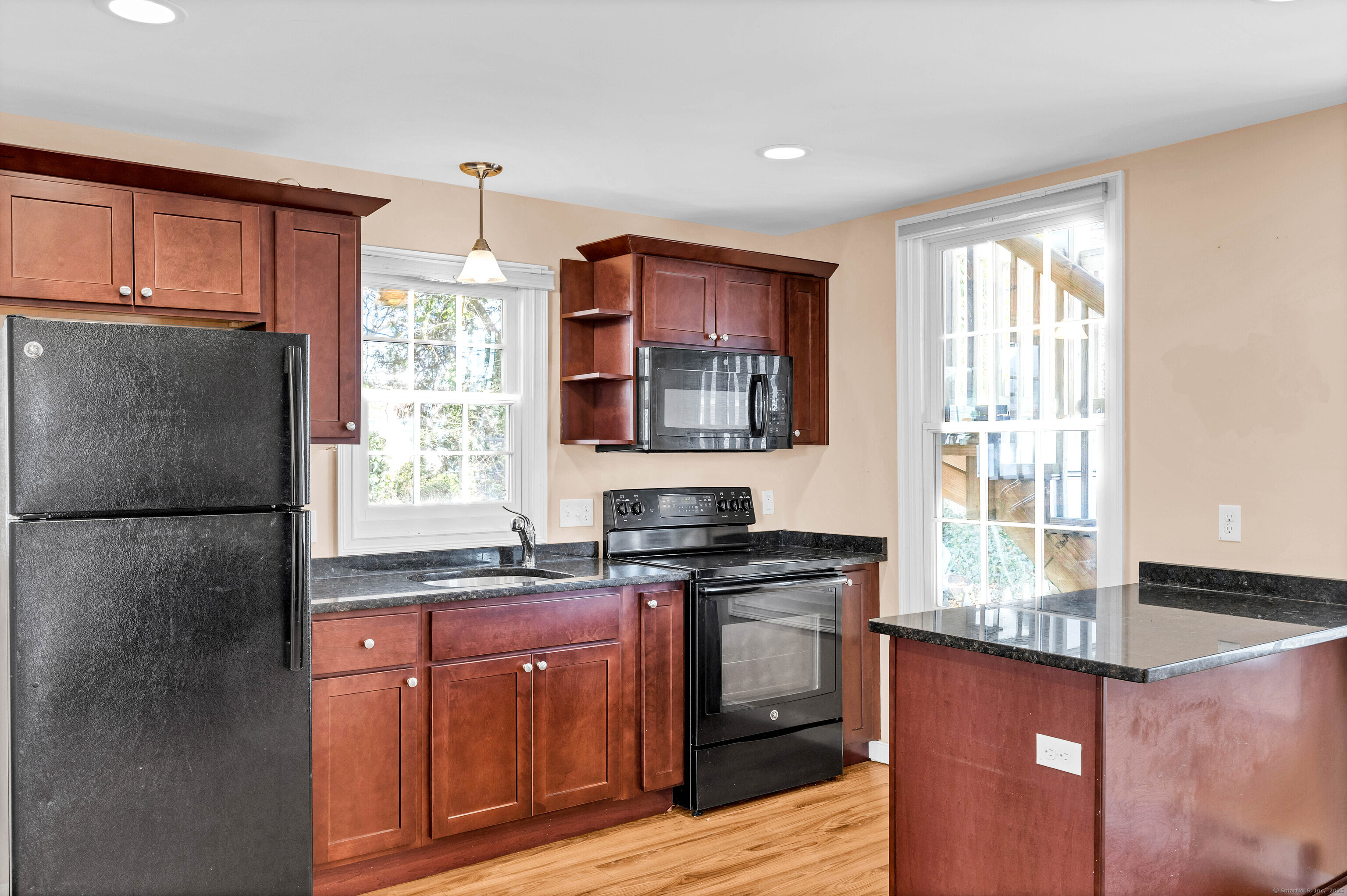 9 Brewer Street New London, CT 06320 - Photo 22 of 40 a kitchen with granite countertop a refrigerator stove top oven and sink