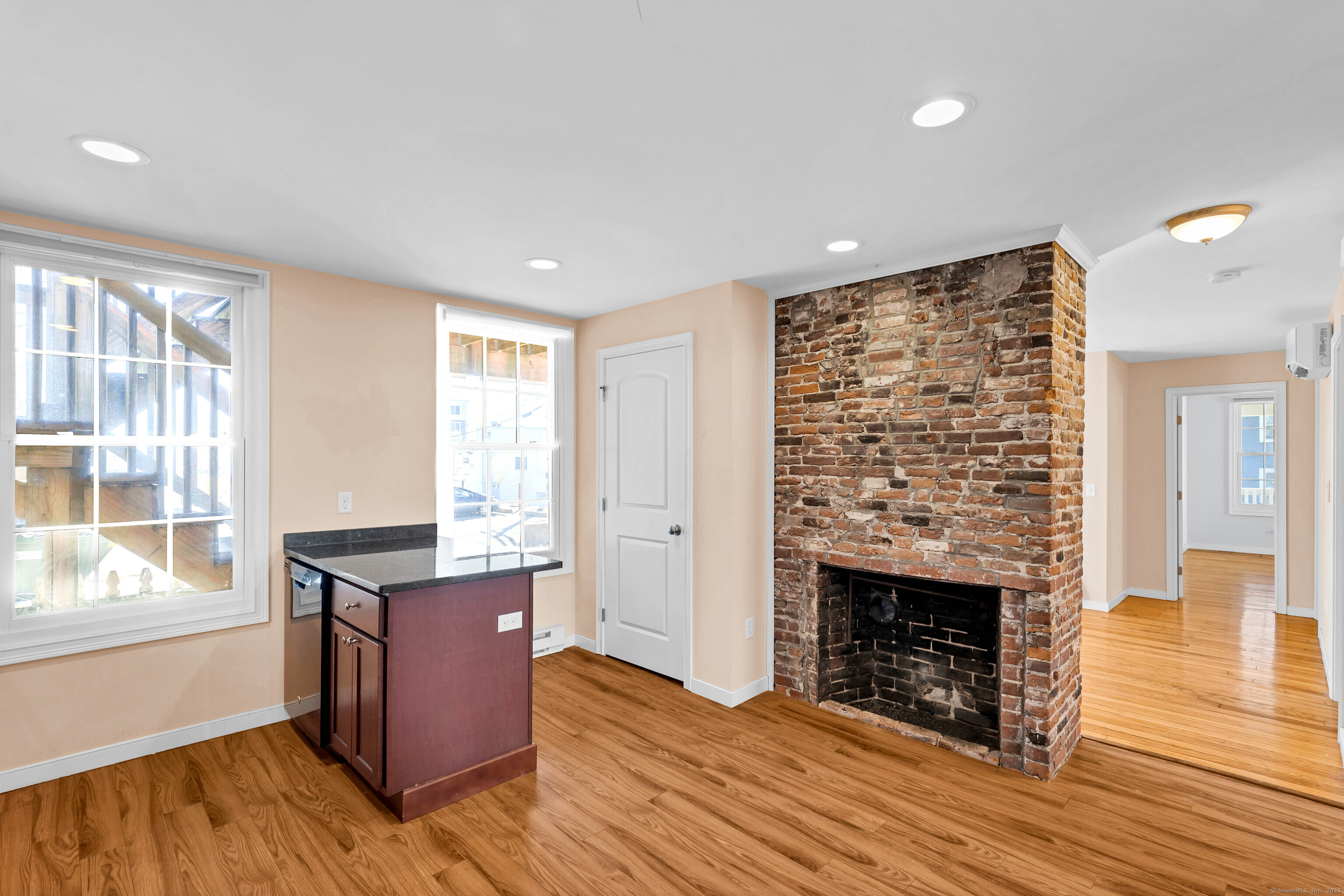 9 Brewer Street New London, CT 06320 - Photo 24 of 40 a view of kitchen with granite countertop kitchen island wooden floors and a fireplace