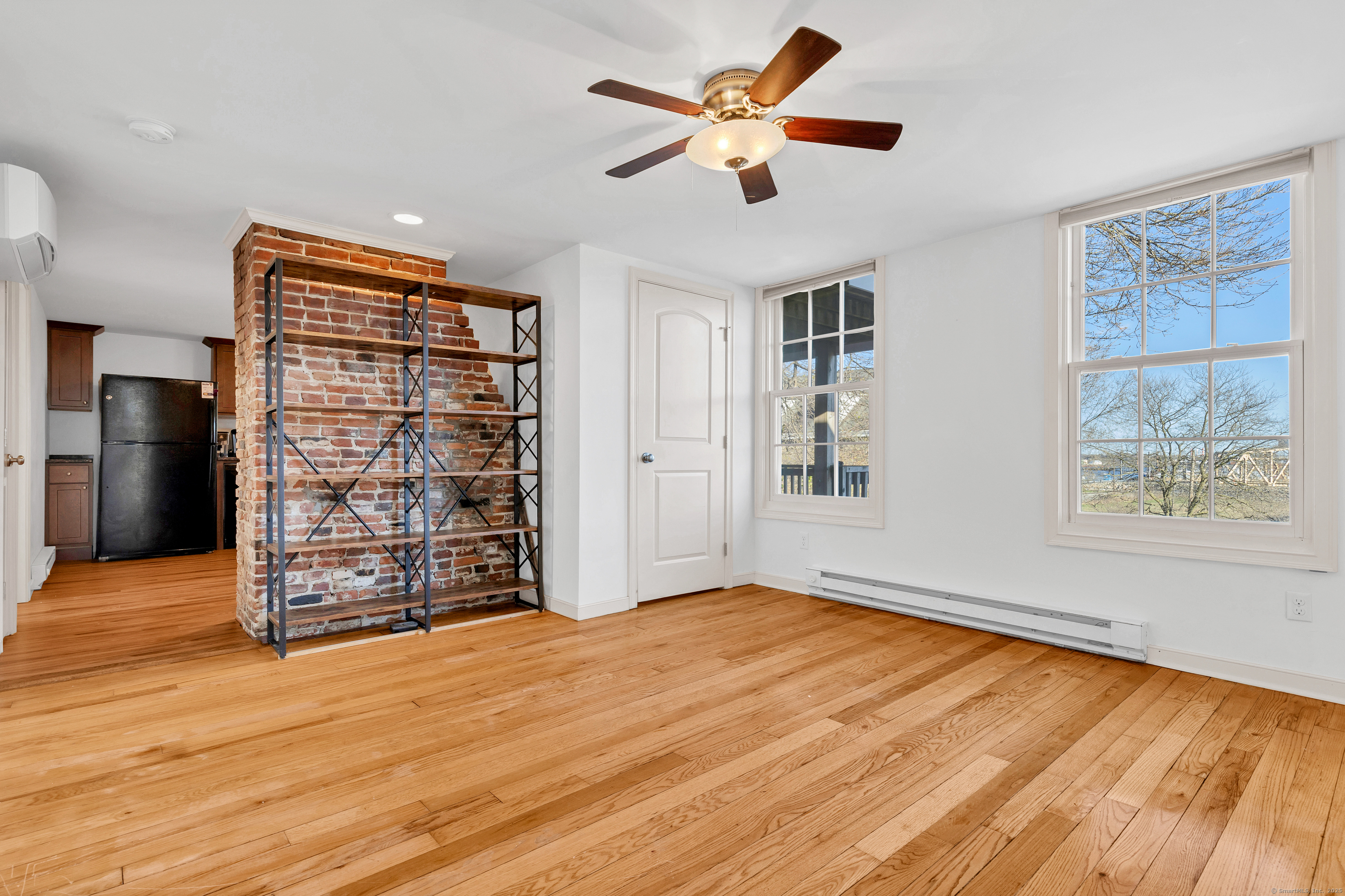 9 Brewer Street New London, CT 06320 - Photo 34 of 40 a view of an empty room with a window and wooden floor
