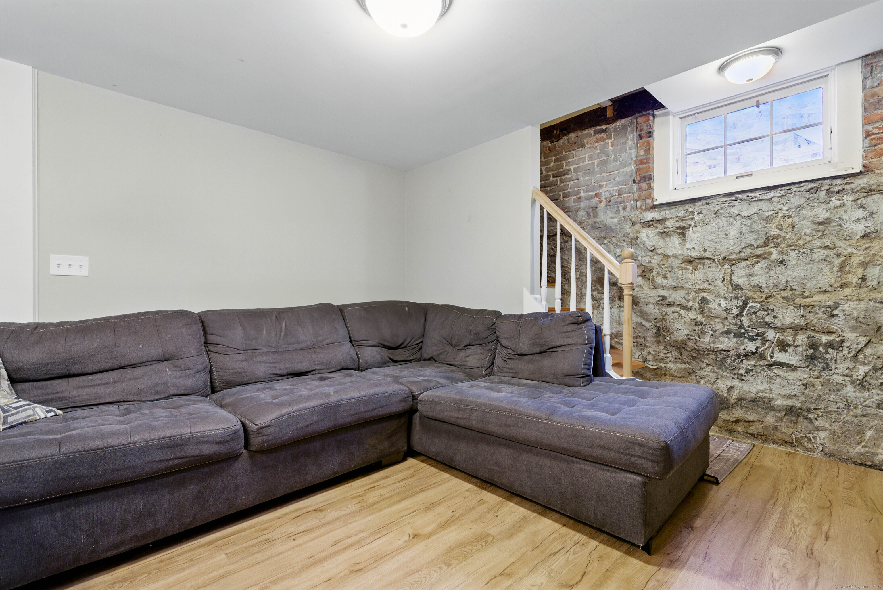9 Brewer Street New London, CT 06320 - Photo 36 of 40 a living room with couches and a kitchen view with wooden floor