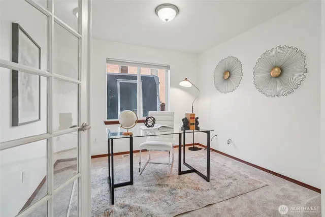 a work room with table chairs and entryway
