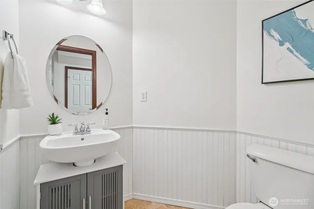 a bathroom with a sink a toilet and mirror
