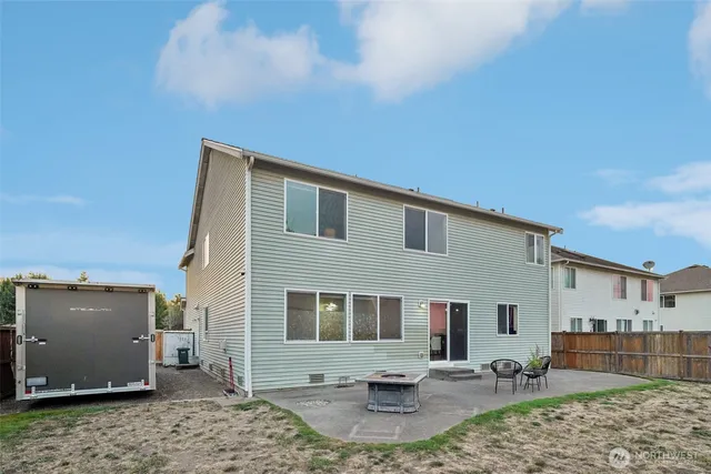 a backyard of a house with barbeque oven and barbeque oven