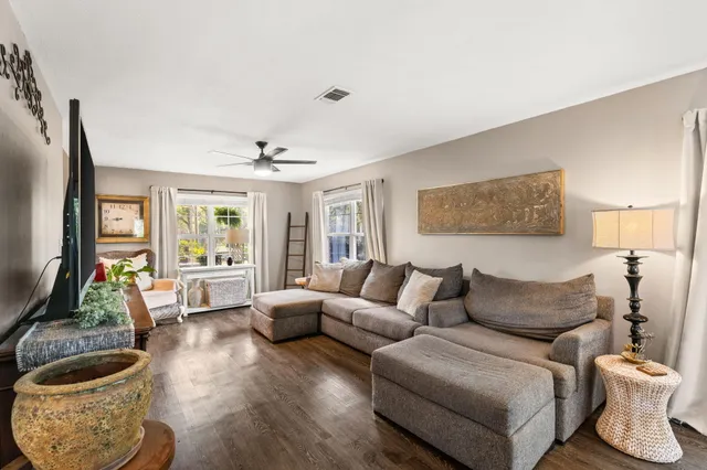 a living room with furniture and a wooden floor