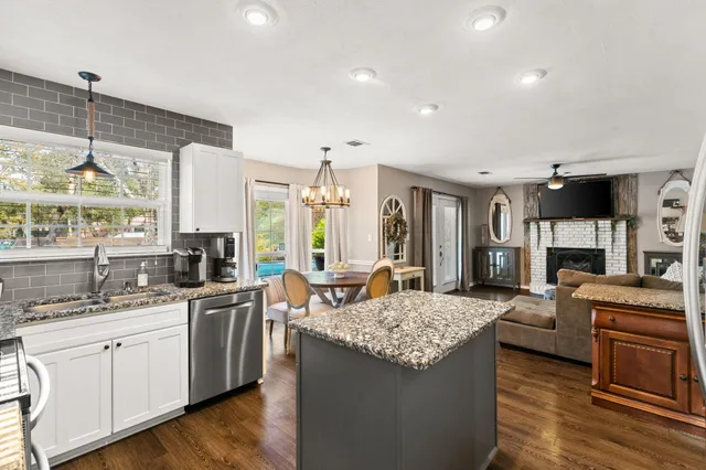a kitchen with a stove a sink and a refrigerator