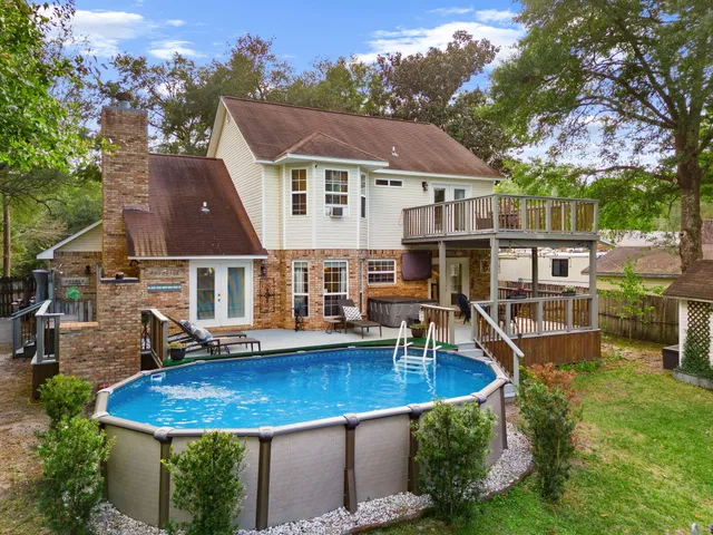 an aerial view of a house with swimming pool and porch