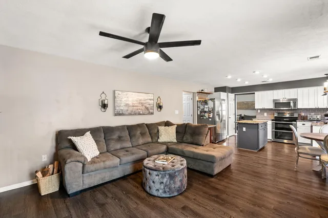 a living room with furniture and kitchen view