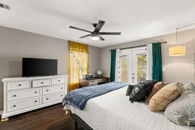 a bedroom with a bed and a flat screen tv