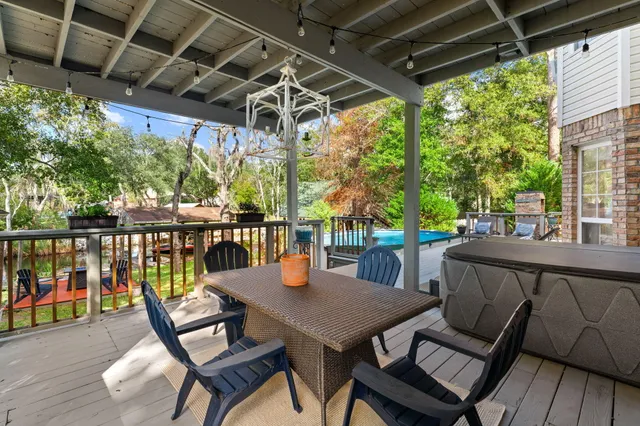 a view of house with backyard outdoor seating and lake view