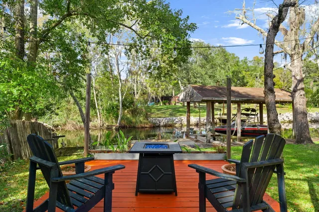 a living room with furniture a flat screen tv and a table
