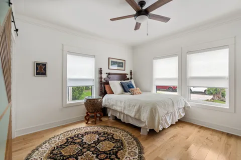 a bedroom with a large bed and a window
