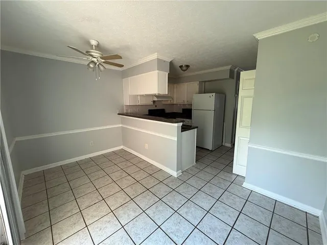 a kitchen with a sink a stove top oven and cabinets