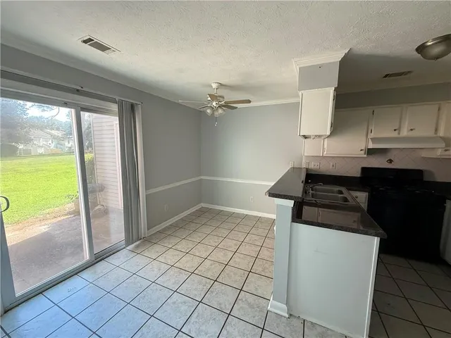 a kitchen with a sink a stove and a refrigerator