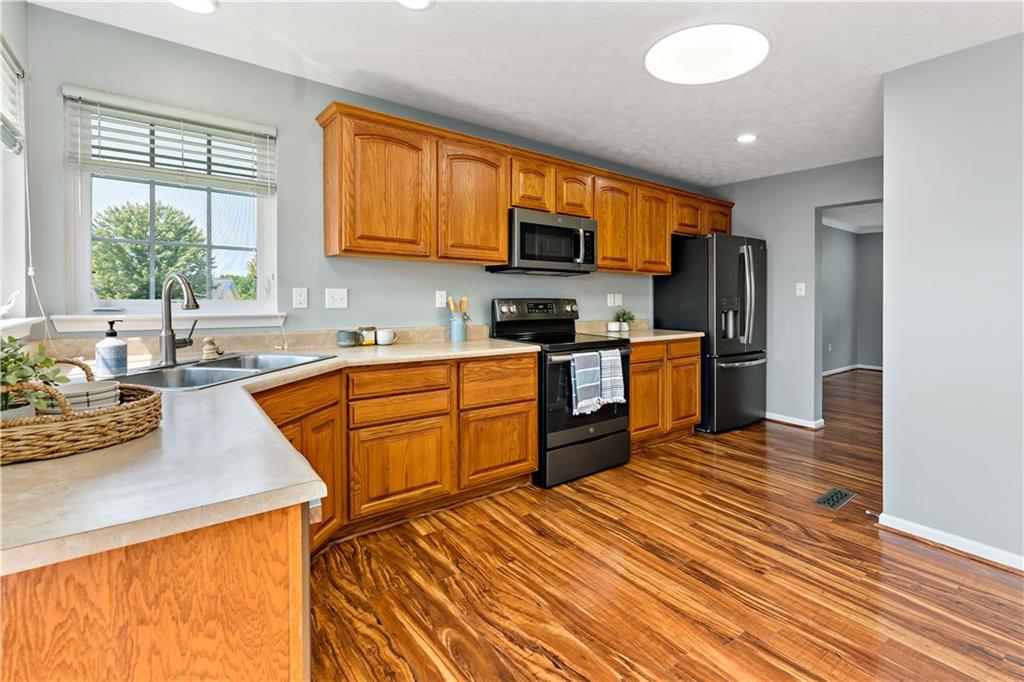 2000 Michael Drive Pittsburgh, PA 15227 - Photo 13 of 45 a kitchen with stainless steel appliances granite countertop wooden cabinets a sink dishwasher a stove and a refrigerator with wooden floor