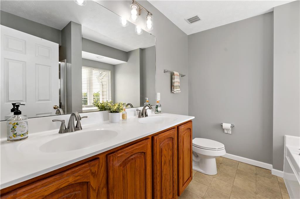 2000 Michael Drive Pittsburgh, PA 15227 - Photo 20 of 45 a bathroom with a sink a toilet and a large mirror