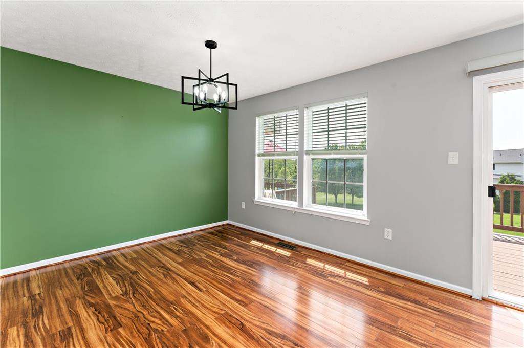 2000 Michael Drive Pittsburgh, PA 15227 - Photo 10 of 45 a view of a room with a large window ceiling fan and hardwood floor