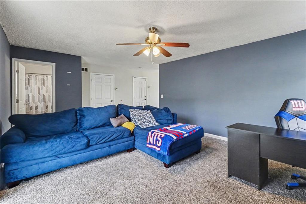 829 Dunes Way Austell, GA 30106 - Photo 12 of 28 a living room with a couch and chandelier