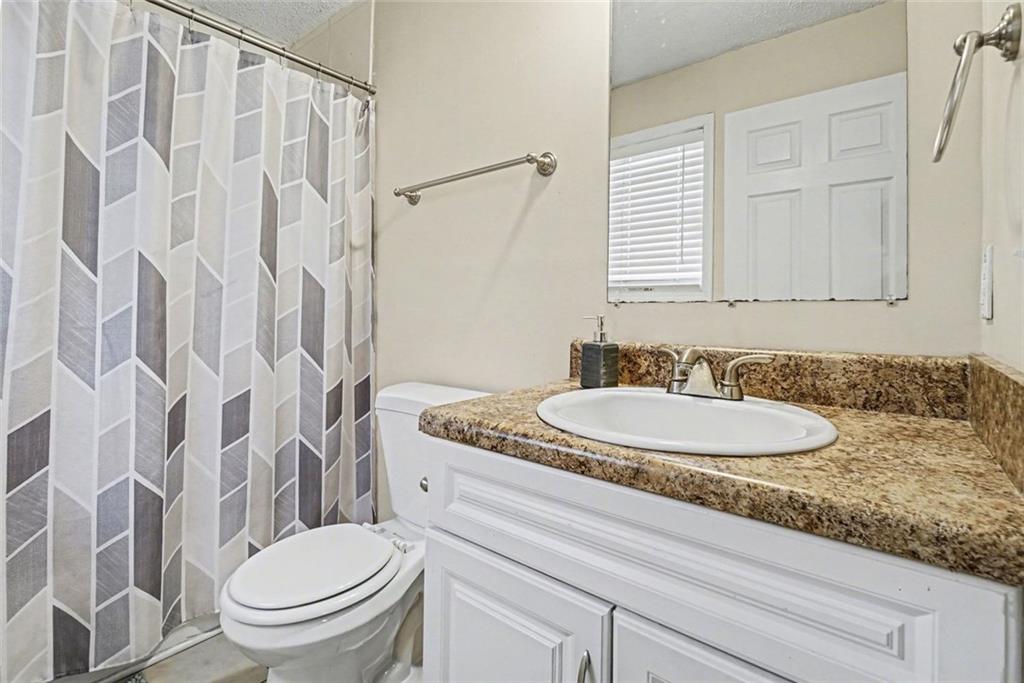 829 Dunes Way Austell, GA 30106 - Photo 15 of 28 a bathroom with a granite countertop sink and a mirror