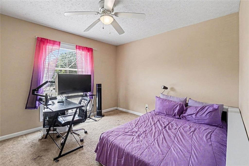 829 Dunes Way Austell, GA 30106 - Photo 17 of 28 a bedroom with a bed and a flat screen tv