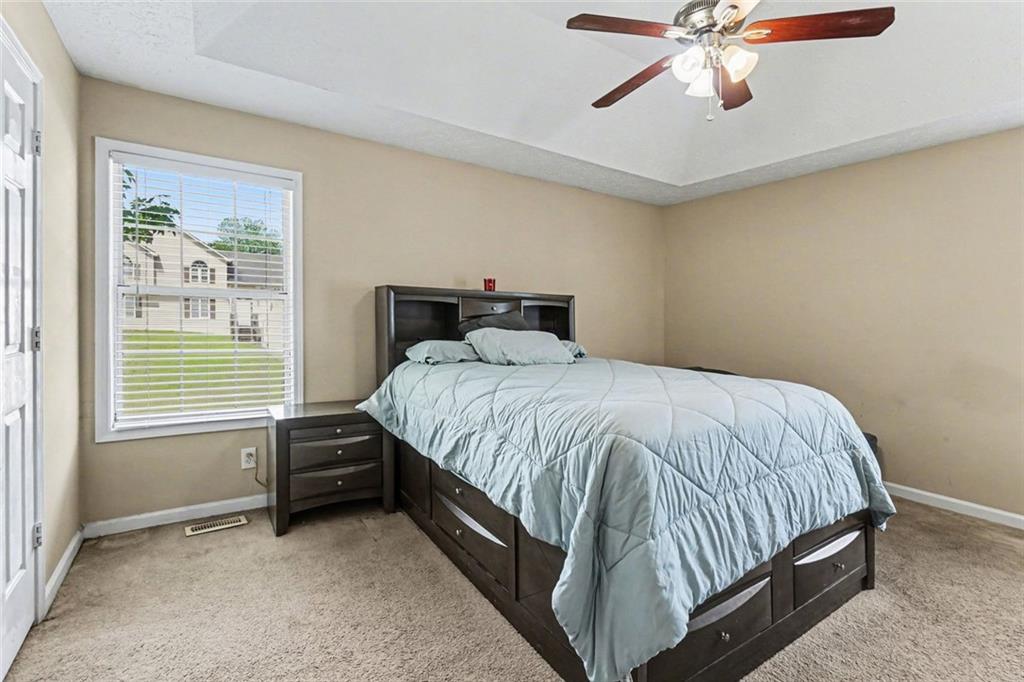 829 Dunes Way Austell, GA 30106 - Photo 18 of 28 a bed sitting in a bedroom next to a window