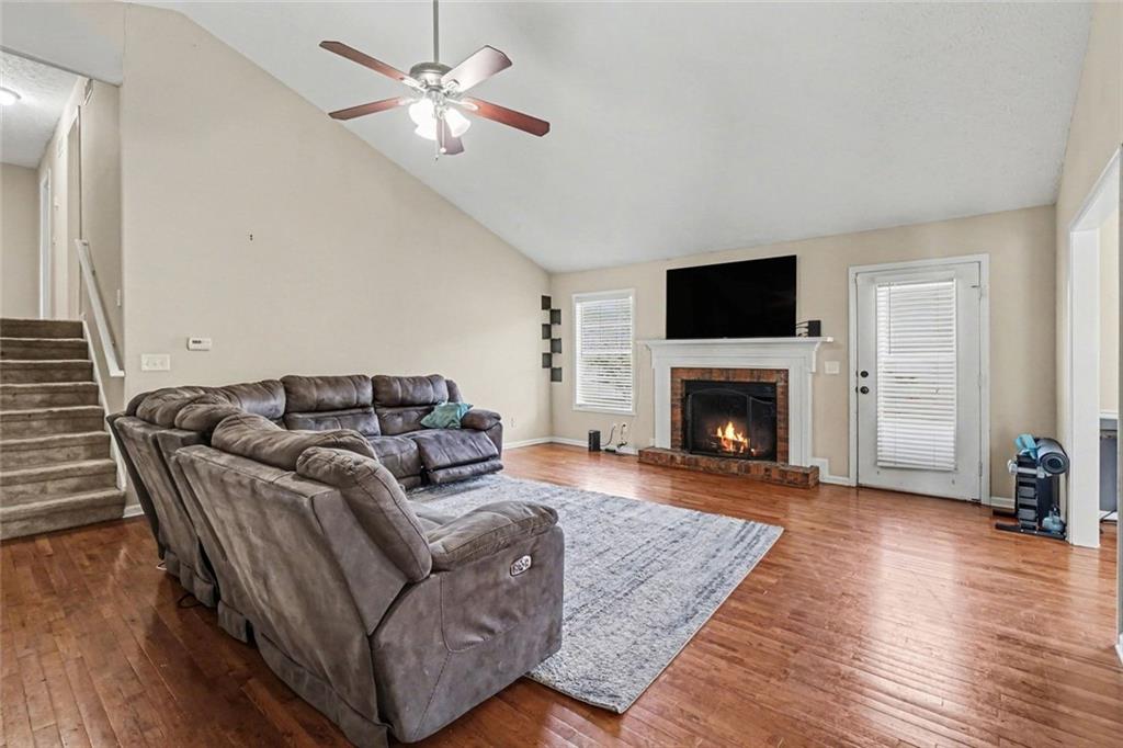829 Dunes Way Austell, GA 30106 - Photo 6 of 28 a living room with furniture a flat screen tv and a fireplace