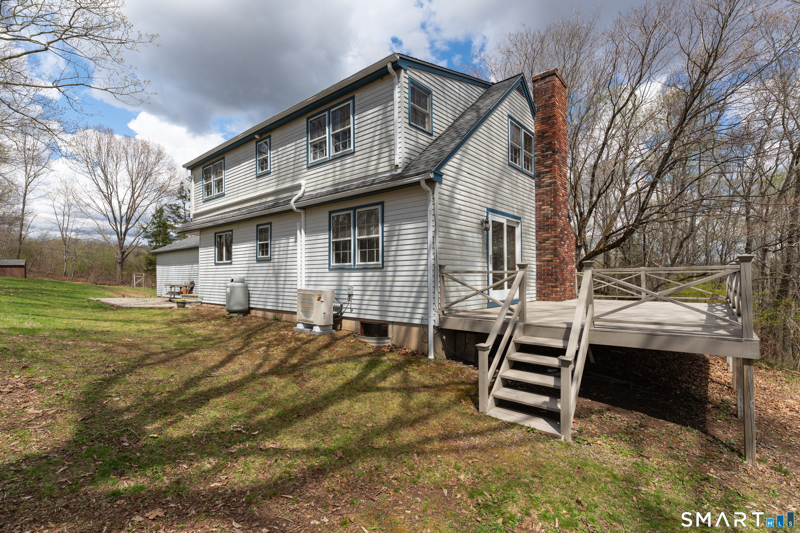 94 Quonnipaug Hill Road Guilford, CT 06437 - Photo 5 of 39 a backyard of a house with barbeque oven and outdoor seating