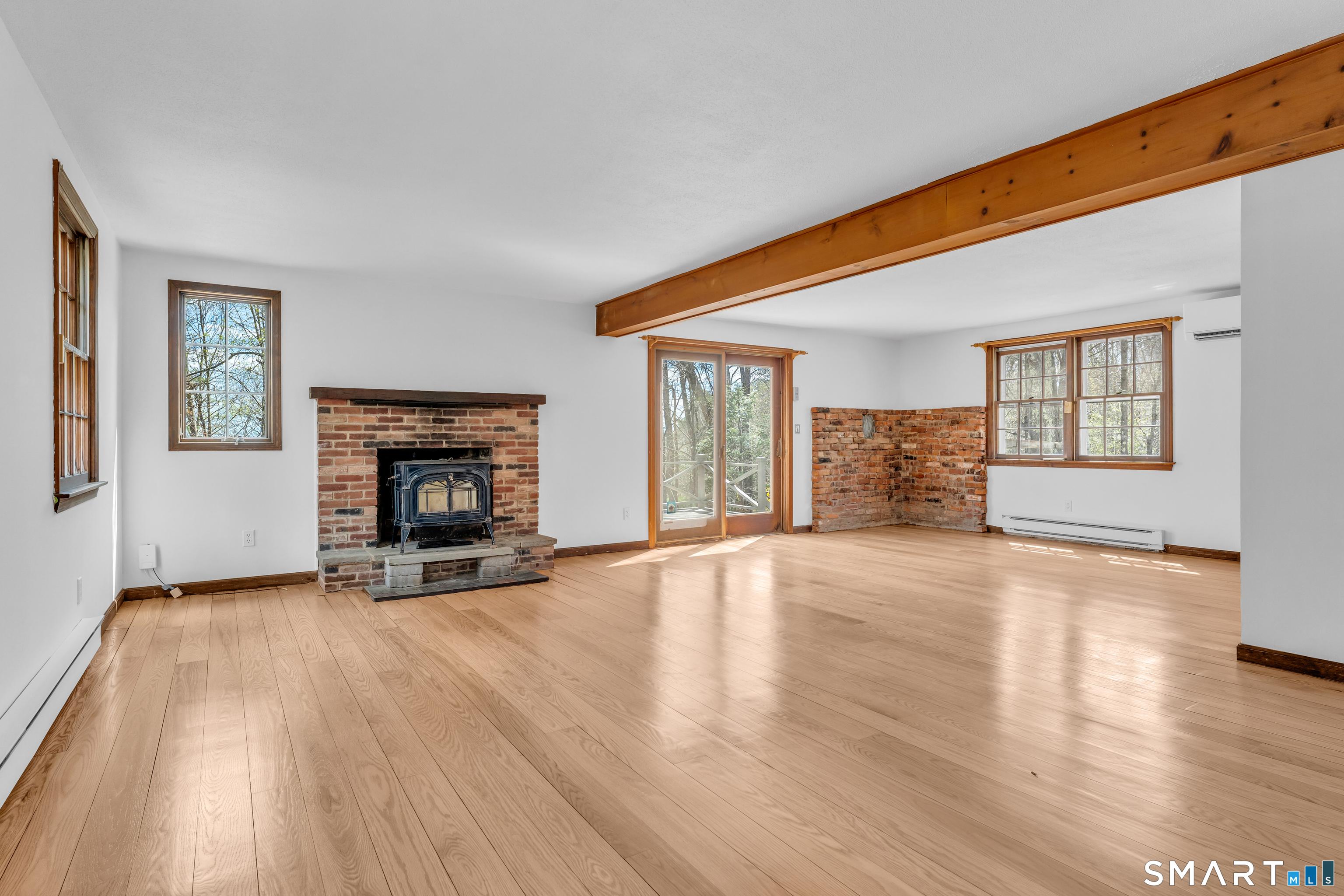 94 Quonnipaug Hill Road Guilford, CT 06437 - Photo 8 of 39 an empty room with windows and fireplace