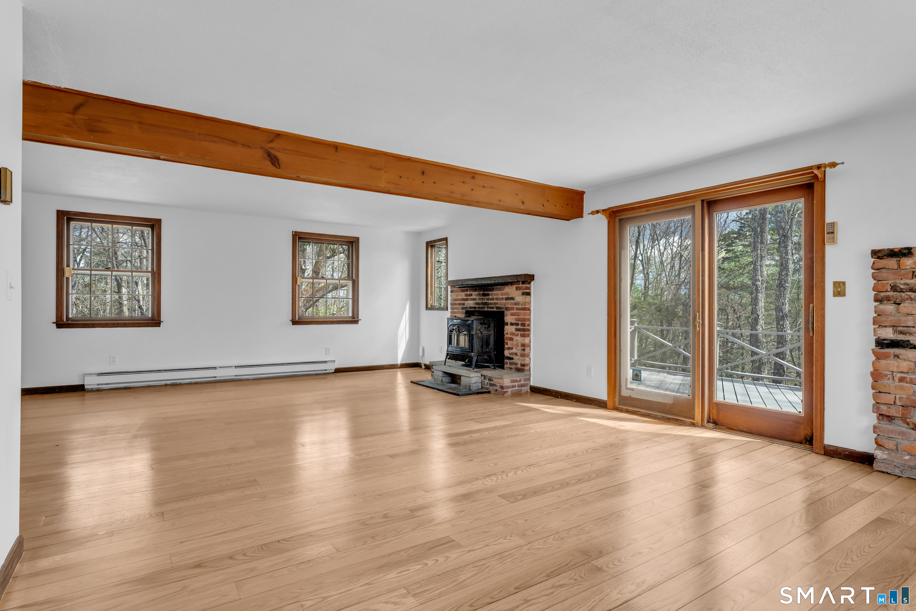 94 Quonnipaug Hill Road Guilford, CT 06437 - Photo 9 of 39 a view of empty room with wooden floor and fan