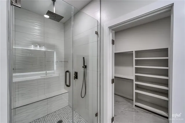 a bathroom with a shower and a glass door
