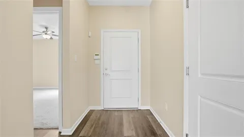 a view of a room with wooden floor
