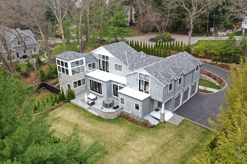 4 Dewing Path Wellesley, MA 02482 - Photo 2 of 41 a aerial view of a house with a yard table and chairs