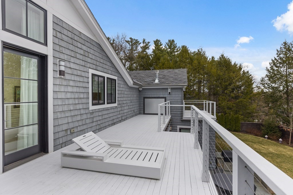 4 Dewing Path Wellesley, MA 02482 - Photo 33 of 41 a view of a deck with two chair and a floor to ceiling window