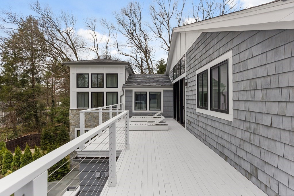 4 Dewing Path Wellesley, MA 02482 - Photo 34 of 41 a view of a house with a large window and wooden fence