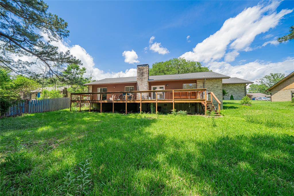 1006 Rikkity Lane Mount Pleasant, TX 75455 - Photo 27 of 39 a view of a house with backyard and a large tree