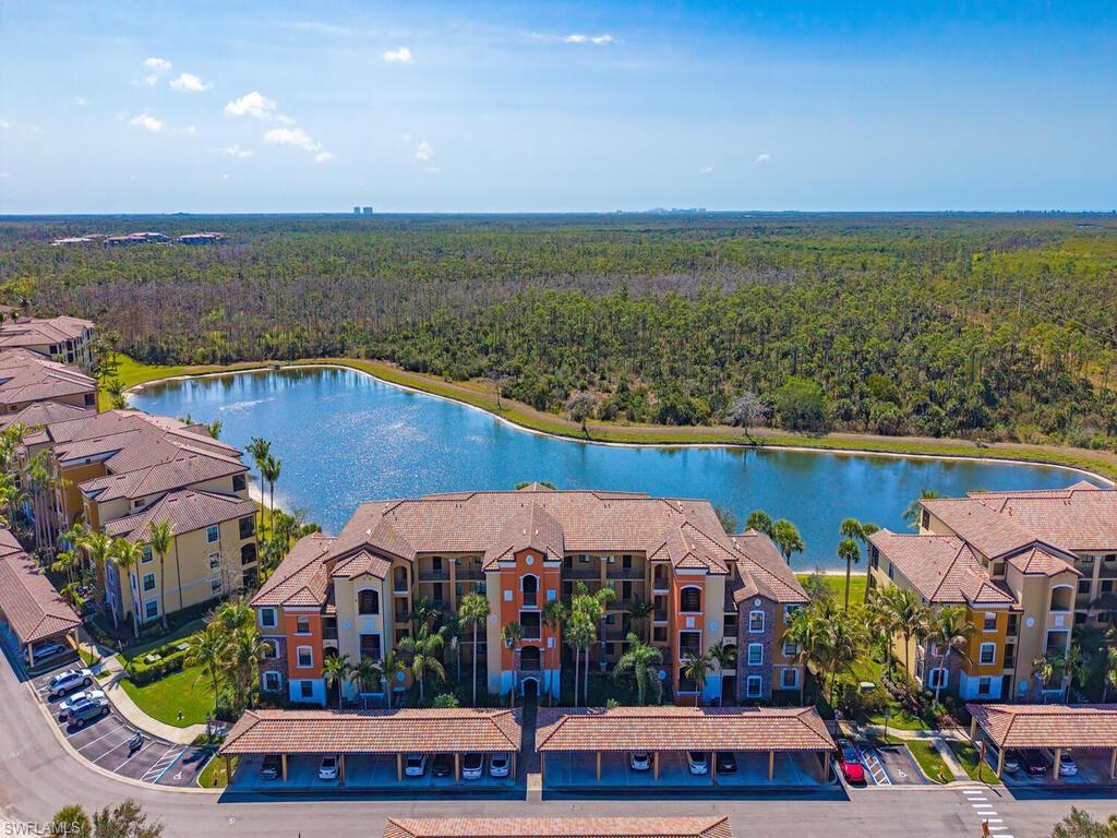 9731 Acqua Court, Unit 514 Naples, FL 34113 - Photo 12 of 21 Drone / aerial view of a forest and a large body of water
