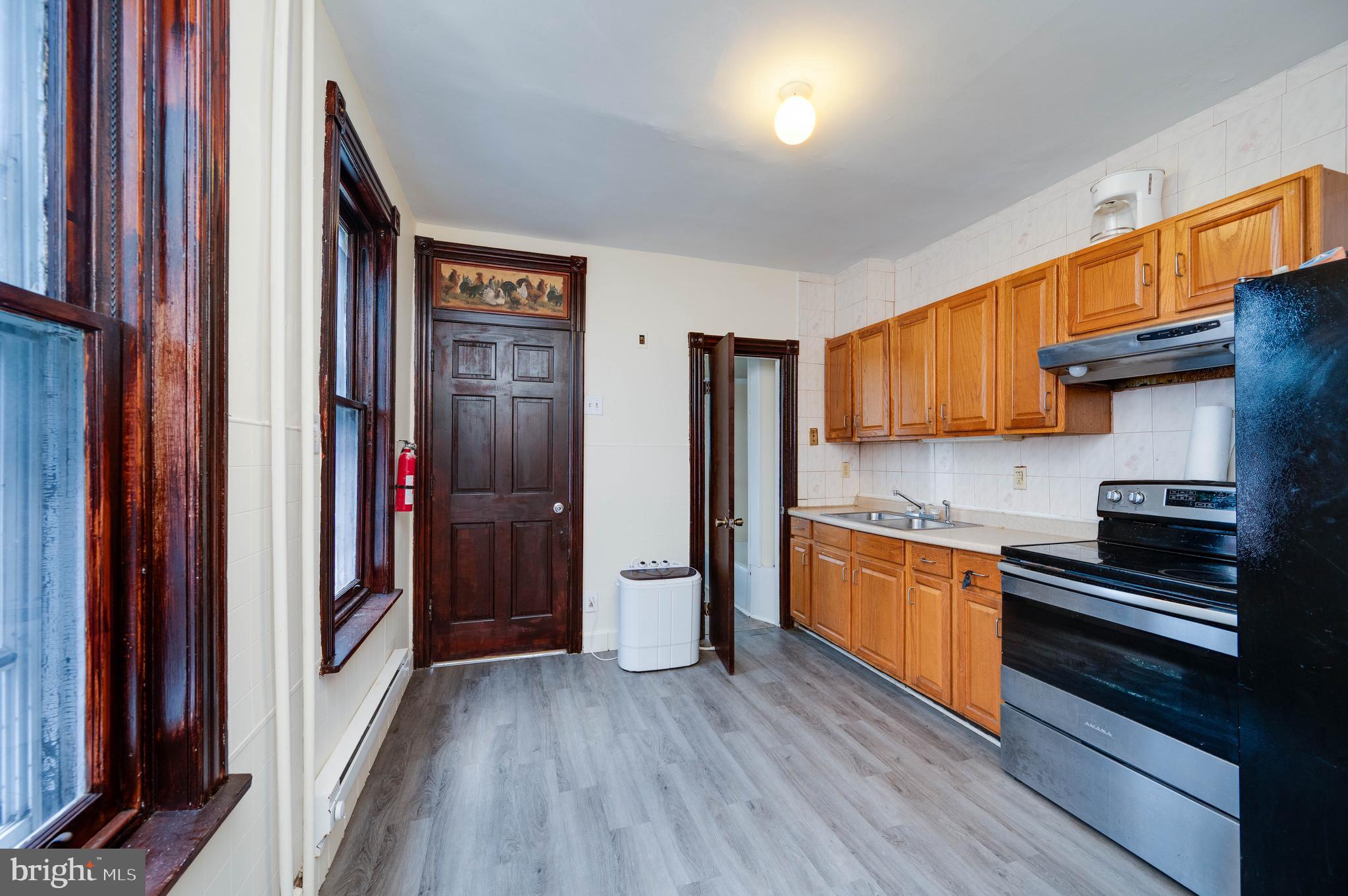 1032 North 5th Street Reading, PA 19601 - Photo 14 of 45 a kitchen with stainless steel appliances granite countertop a refrigerator and a stove top oven