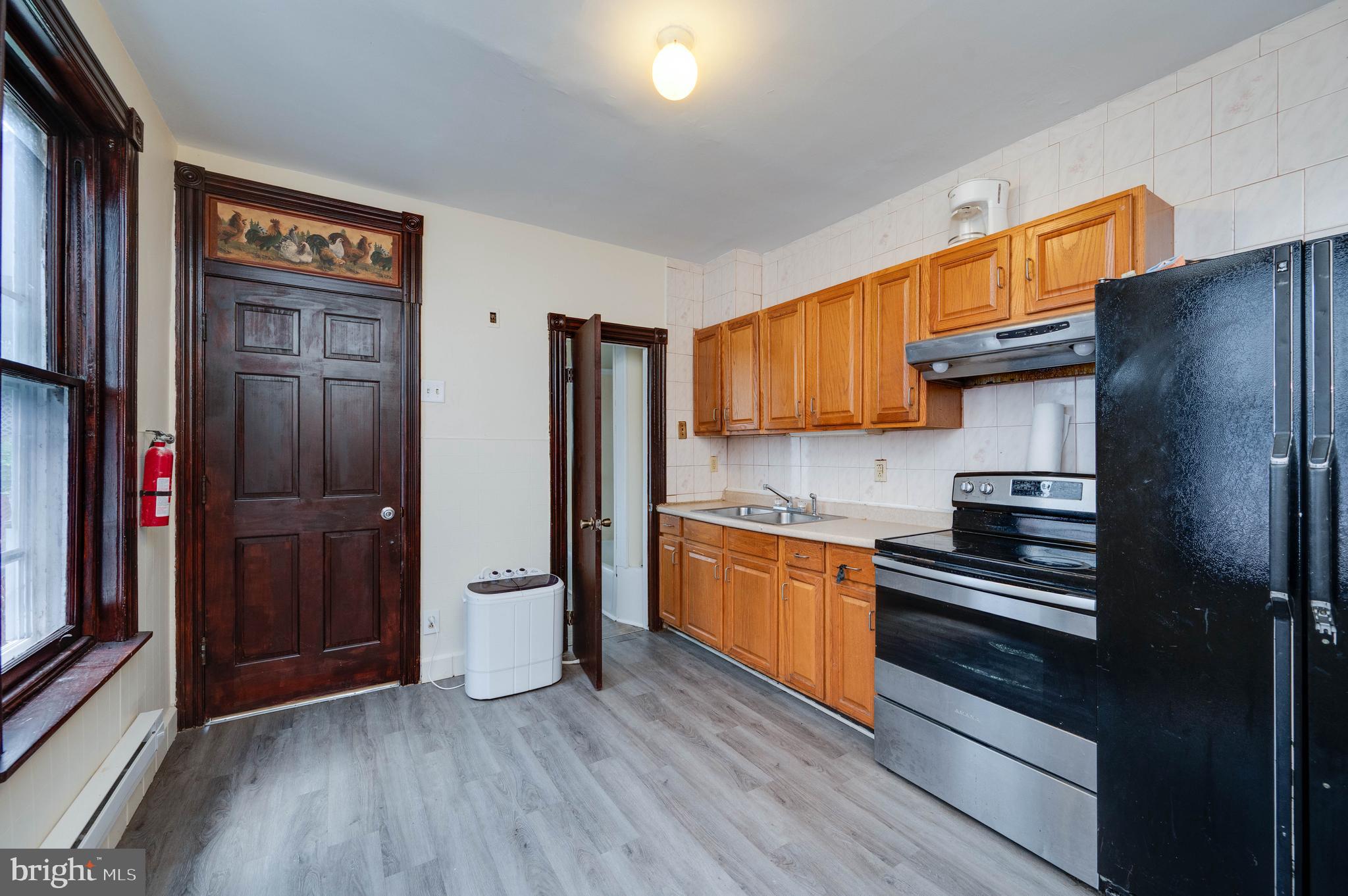 1032 North 5th Street Reading, PA 19601 - Photo 15 of 45 a kitchen with stainless steel appliances granite countertop a refrigerator and a stove top oven