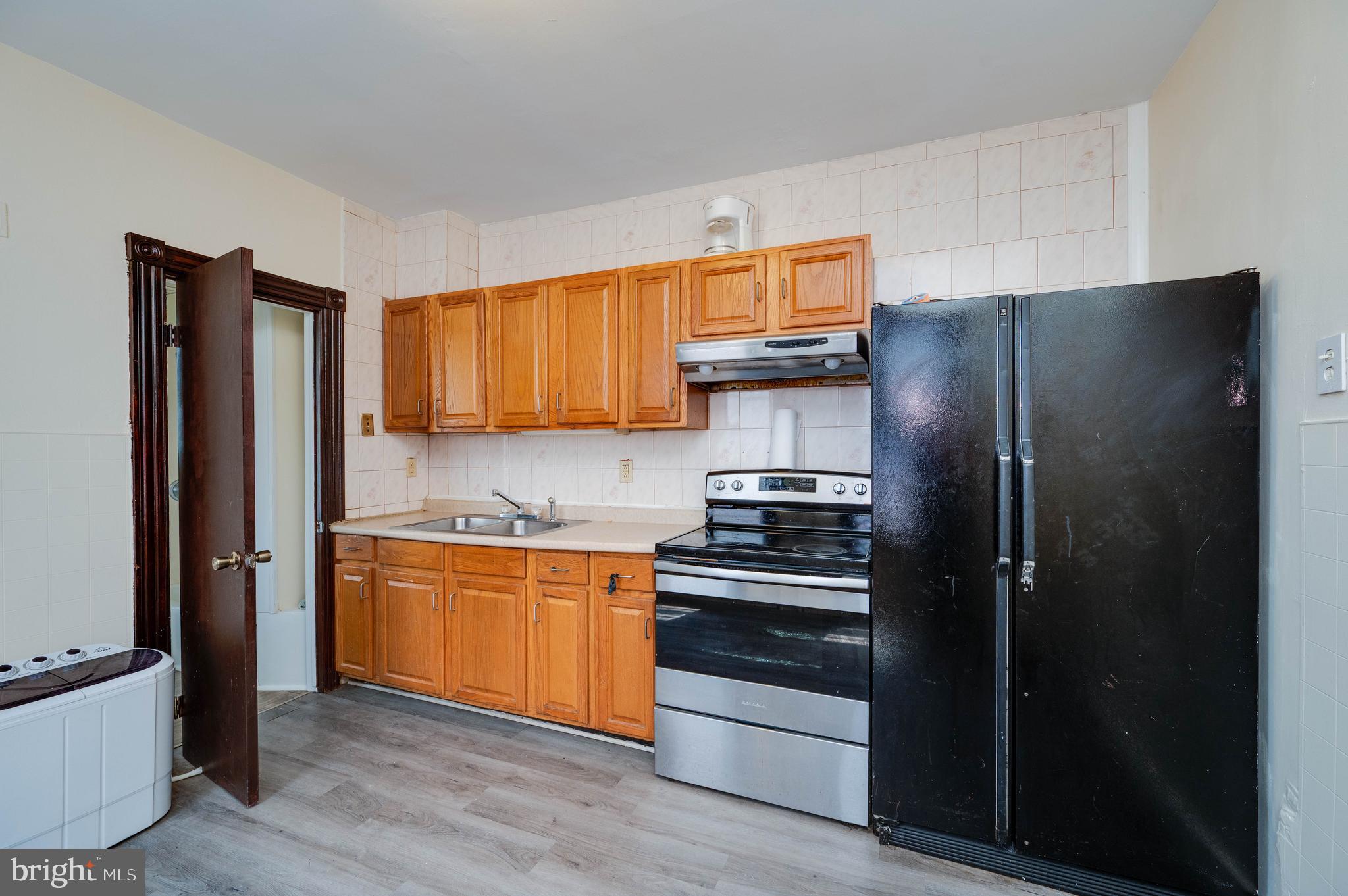 1032 North 5th Street Reading, PA 19601 - Photo 16 of 45 a kitchen with stainless steel appliances granite countertop a refrigerator and a sink