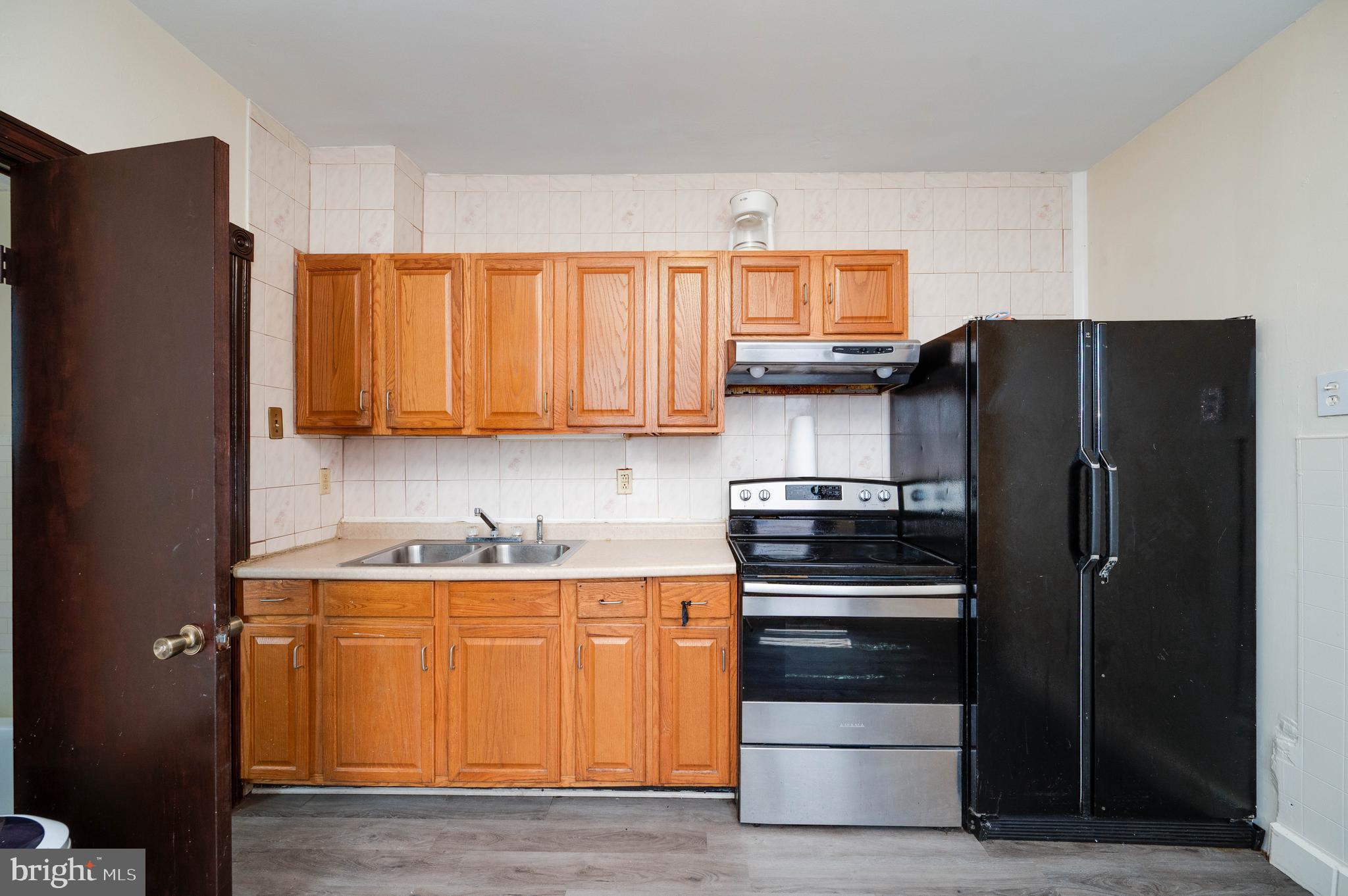 1032 North 5th Street Reading, PA 19601 - Photo 17 of 45 a kitchen with stainless steel appliances granite countertop a refrigerator and a sink