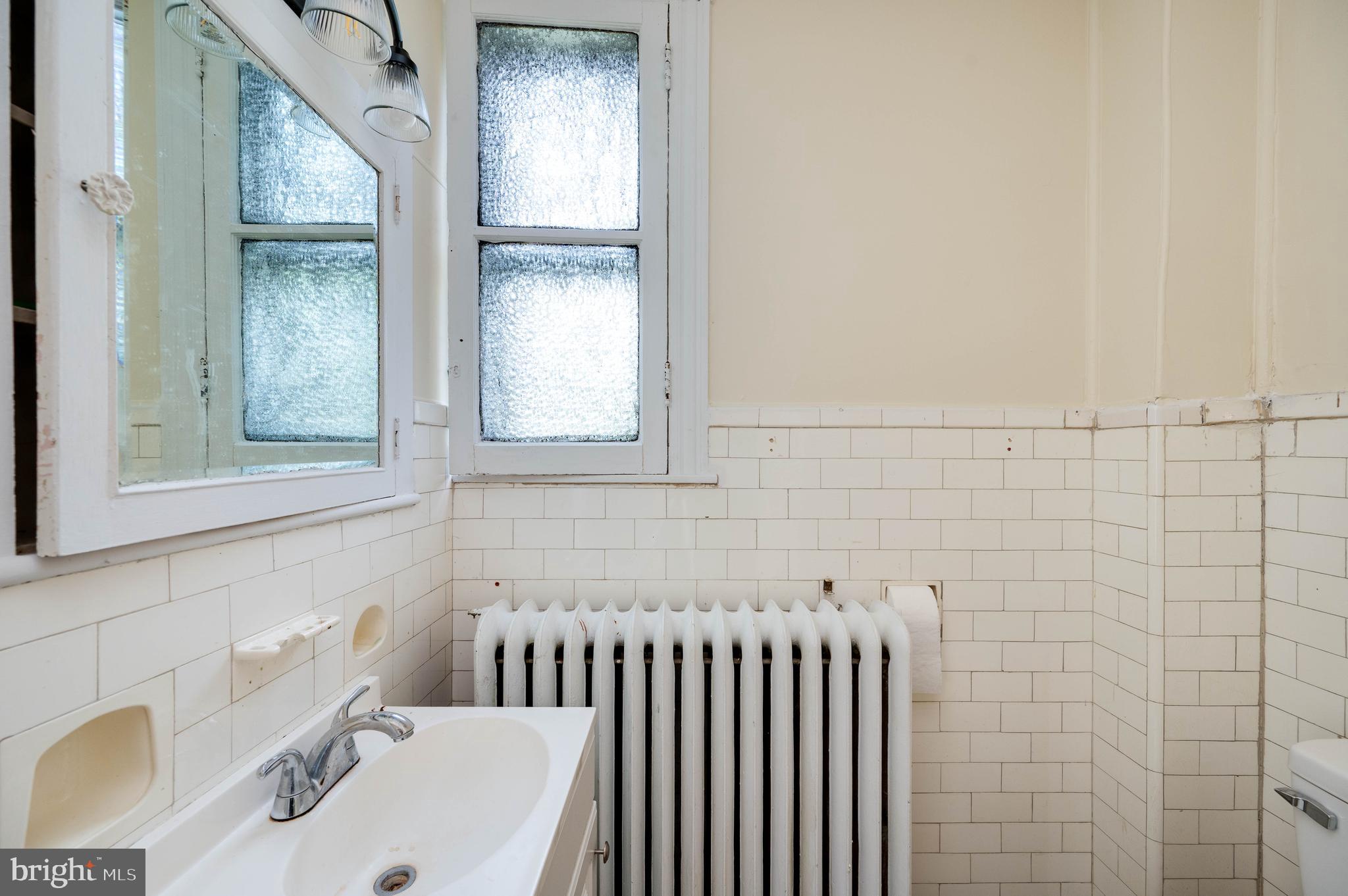 1032 North 5th Street Reading, PA 19601 - Photo 20 of 45 a bathroom with a sink and a mirror