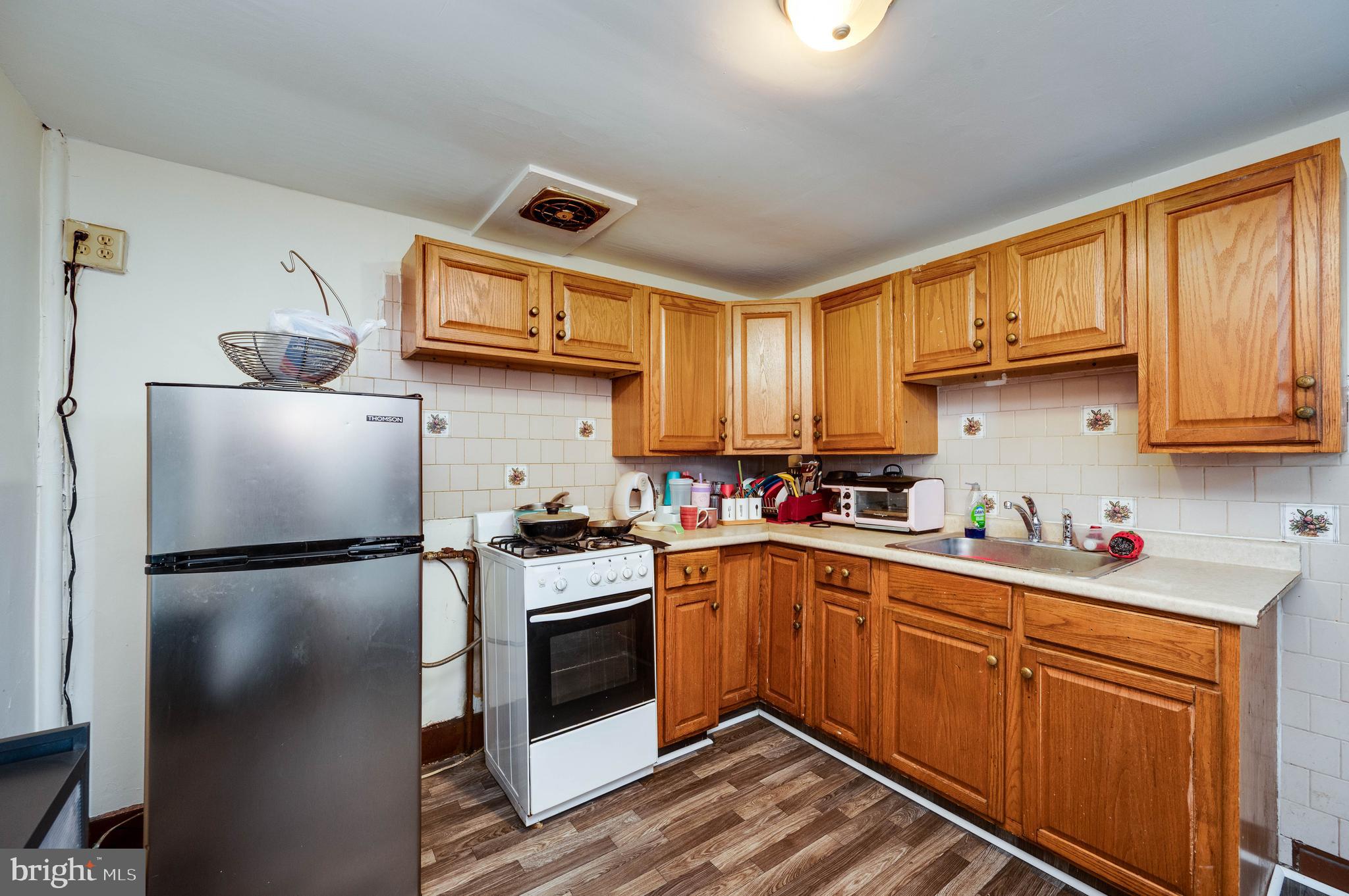 1032 North 5th Street Reading, PA 19601 - Photo 21 of 45 a kitchen with stainless steel appliances granite countertop a refrigerator sink and cabinets